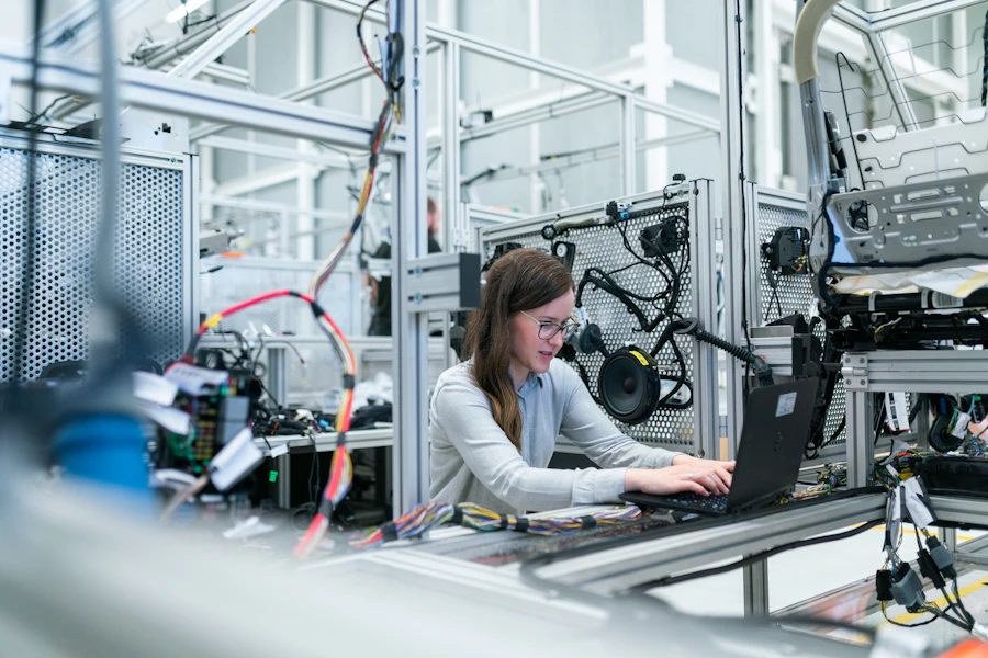 Engineer monitoring industrial equipment and IoT sensors on a laptop